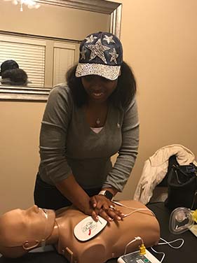 Woman Performing CPR on a Dummy