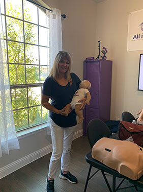 Woman With Infant CPR Dummy